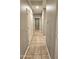 Clean hallway with tile flooring and neutral walls at 13613 W Cypress St, Goodyear, AZ 85395