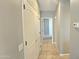 Hallway with tile flooring, neutral gray paint and access to other rooms in the house at 13613 W Cypress St, Goodyear, AZ 85395