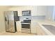 This kitchen features stainless steel appliances, quartz counters, and white cabinets at 13613 W Cypress St, Goodyear, AZ 85395