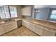 Kitchen with beige countertops and white cabinets at 13613 W Cypress St, Goodyear, AZ 85395