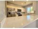 A bright kitchen with stainless steel appliances, white cabinetry, and granite countertops at 13613 W Cypress St, Goodyear, AZ 85395