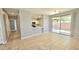 An open concept view of the living room, kitchen, and dining area with tile flooring at 13613 W Cypress St, Goodyear, AZ 85395