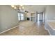 The living room boasts tile flooring leading to a carpeted area, a fireplace, and a ceiling fan at 13613 W Cypress St, Goodyear, AZ 85395