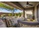 Relaxing covered patio with seating area and view of landscaped backyard at 16413 E Westwind Ct, Fountain Hills, AZ 85268