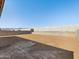 A blank backyard with a retaining wall and blue sky overhead at 17648 W Pierson St, Goodyear, AZ 85395