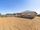 A blank backyard with a retaining wall and a single-story home at 17648 W Pierson St, Goodyear, AZ 85395