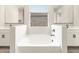 Bright bathroom featuring white cabinets, large tub and stylish finishes at 17648 W Pierson St, Goodyear, AZ 85395