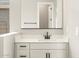 Bathroom featuring white cabinets, neutral paint, and sleek black hardware at 17648 W Pierson St, Goodyear, AZ 85395