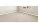 Neutral bedroom showcasing plush carpeting and natural lighting at 17648 W Pierson St, Goodyear, AZ 85395