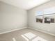 Bright bedroom with a large window and plush carpeting at 17648 W Pierson St, Goodyear, AZ 85395