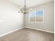 Bright dining room with stylish chandelier and natural light from the window at 17648 W Pierson St, Goodyear, AZ 85395