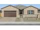 Charming single-story home featuring desert landscaping and a private gated front entry at 17648 W Pierson St, Goodyear, AZ 85395