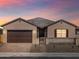 Inviting single-story home featuring a two-car garage, covered entry, and gated front yard at 17648 W Pierson St, Goodyear, AZ 85395