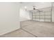 An empty two car garage with concrete floor and white walls at 17648 W Pierson St, Goodyear, AZ 85395