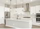 Modern kitchen featuring a large center island, stainless steel appliances, and pendant lighting at 17648 W Pierson St, Goodyear, AZ 85395