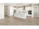 Bright kitchen featuring stainless steel appliances, a spacious island, and white cabinetry at 17648 W Pierson St, Goodyear, AZ 85395