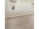 A living space featuring modern flooring and neutral-colored walls at 17648 W Pierson St, Goodyear, AZ 85395
