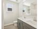 Bathroom with a grey double sink vanity and tile flooring at 17737 W Elm St, Goodyear, AZ 85395