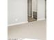 Hallway view of the bathroom area with wood look flooring, grey cabinets, and a white counter at 17737 W Elm St, Goodyear, AZ 85395