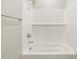 White tiled bathtub shower combination in a new construction bathroom at 17737 W Elm St, Goodyear, AZ 85395