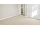 Bright bedroom with neutral carpet, white trim, and closet with paneled doors at 17737 W Elm St, Goodyear, AZ 85395
