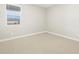 Neutral bedroom with a window and neutral carpet at 17737 W Elm St, Goodyear, AZ 85395