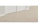 Close up view of a neutral bedroom carpet with trim and door at 17737 W Elm St, Goodyear, AZ 85395