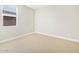 Neutral bedroom with a window and neutral carpet at 17737 W Elm St, Goodyear, AZ 85395