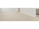 Neutral carpeted bedroom with white trim, baseboards, and a doorway at 17737 W Elm St, Goodyear, AZ 85395