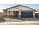 Charming single Gathering home featuring stylish stonework, a two-car garage, and a welcoming entryway at 17737 W Elm St, Goodyear, AZ 85395