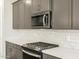 Modern kitchen featuring a built-in microwave, sleek countertops, and stainless steel appliances at 17737 W Elm St, Goodyear, AZ 85395