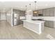 Open kitchen featuring stainless steel appliances and island with pendant lighting at 17737 W Elm St, Goodyear, AZ 85395
