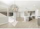 Open living space featuring modern light fixtures, neutral walls, and wood-style tile flooring at 17737 W Elm St, Goodyear, AZ 85395