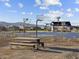 A basketball court with a picnic table on the side is surrounded by new homes and mountains in the background at 17743 W Elm St, Goodyear, AZ 85395