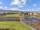 Community amenities include sports courts and playground with green spaces and walking paths amid residential homes at 17749 W Elm St, Goodyear, AZ 85395