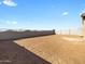 Large backyard features a dirt landscape and block wall for privacy at 17749 W Elm St, Goodyear, AZ 85395