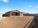 Large backyard with dirt landscape and block wall surrounding the property at 17749 W Elm St, Goodyear, AZ 85395