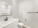 Modern bathroom features single sink vanity, toilet, and shower with white subway tile at 17749 W Elm St, Goodyear, AZ 85395