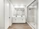 Contemporary bathroom with double sinks, large mirror, and a walk-in shower at 17749 W Elm St, Goodyear, AZ 85395