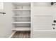 Bathroom boasts bathtub with white subway tile and shelving for storage and decor at 17749 W Elm St, Goodyear, AZ 85395
