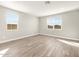 Bright, airy bedroom with wood-look tile floors and natural light from multiple windows at 17749 W Elm St, Goodyear, AZ 85395