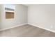 Bright, carpeted bedroom features a window providing natural light at 17749 W Elm St, Goodyear, AZ 85395