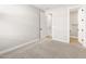 Bedroom featuring neutral walls, carpet, and doors to other rooms in the house at 17749 W Elm St, Goodyear, AZ 85395