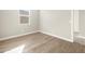 An empty room featuring tile floors and a window for natural light at 17749 W Elm St, Goodyear, AZ 85395