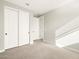 Carpeted bedroom boasts a closet with sliding doors and neutral paint at 17749 W Elm St, Goodyear, AZ 85395