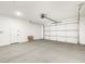 Spacious two car garage with a white door, concrete floors, and overhead lighting at 17749 W Elm St, Goodyear, AZ 85395