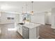 Modern kitchen island featuring stainless steel appliances, quartz countertops, and pendant lighting at 17749 W Elm St, Goodyear, AZ 85395