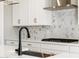 Close-up of modern kitchen finishes, including white cabinets and subway tile at 17749 W Elm St, Goodyear, AZ 85395