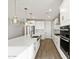 Open kitchen concept with pendant lighting, an island, and modern appliances at 17749 W Elm St, Goodyear, AZ 85395