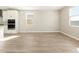 Bright and airy living room featuring wood tile floors and multiple windows for natural light at 17749 W Elm St, Goodyear, AZ 85395